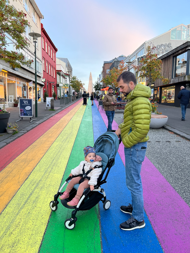 dad pushes child in a stroller on the main walking street in iceland