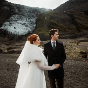 bride and groom hold hands during Ásatrú elopement Ceremony in iceland