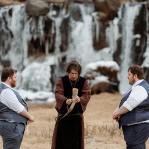 two grooms stand during their Ásatrú Ceremony in iceland and look at officiant