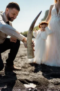 groom dumps liquid out of norse horn during Ásatrú Ceremony in iceland