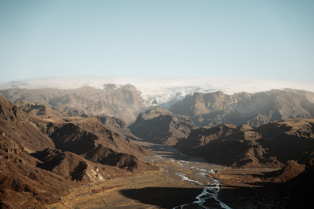 A vast mountain landscape with a winding river below. iceland elopement spot: Þórsmörk Valley