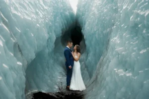 bride and groom stand inside of glacier while at the best place to elope in iceland, Solheimajokull Glacier