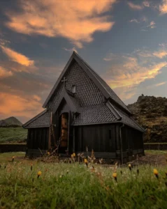 wooden house sits in grassy area at the Westman Islands in iceland