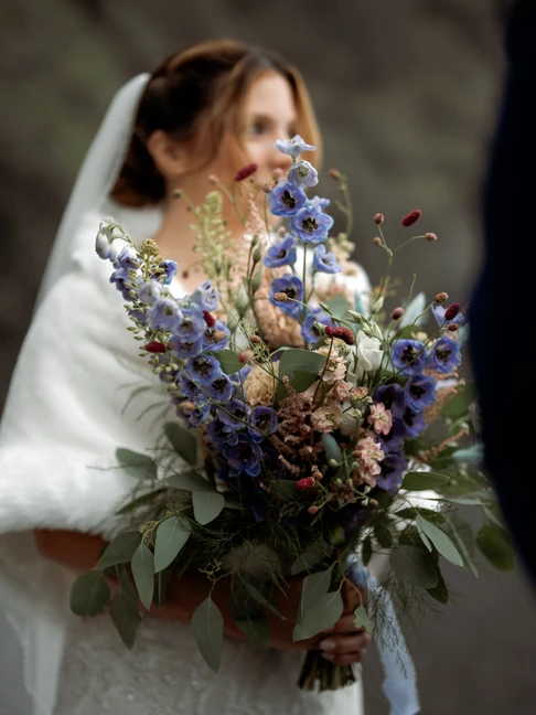 bride hold beautiful colorful elopement bouquet
