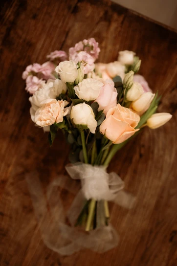 simple and small elopement bouquet sits on a wooden table for an iceland elopement