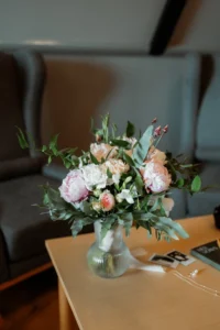 elopement bouquet sits in a case on a table before an iceland wedding