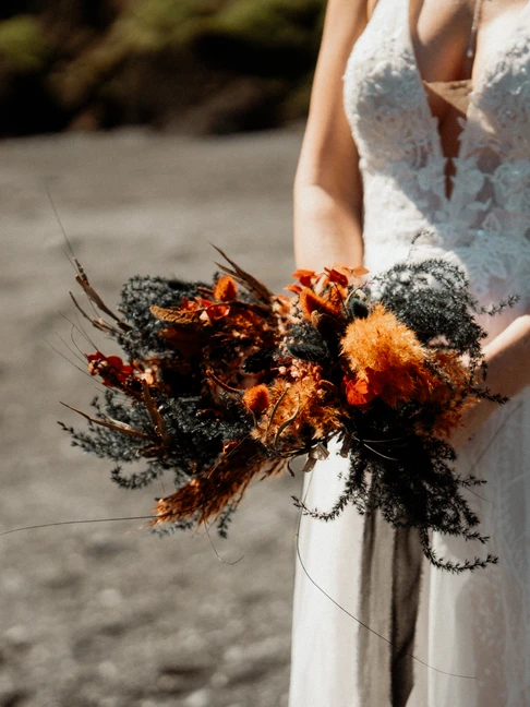 bride holds elopement bouquet during iceland wedding
