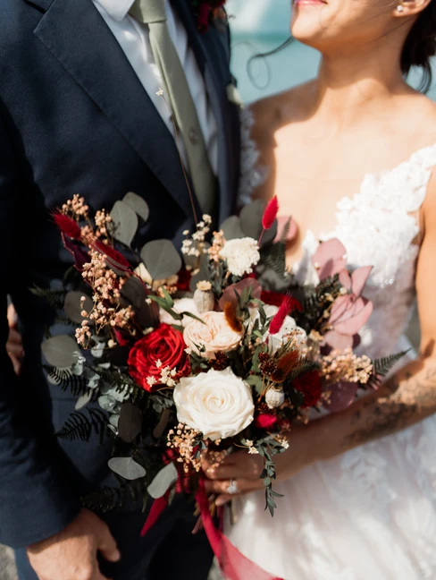 bride looks up at groom while holding her elopement flowers for their iceland elopement