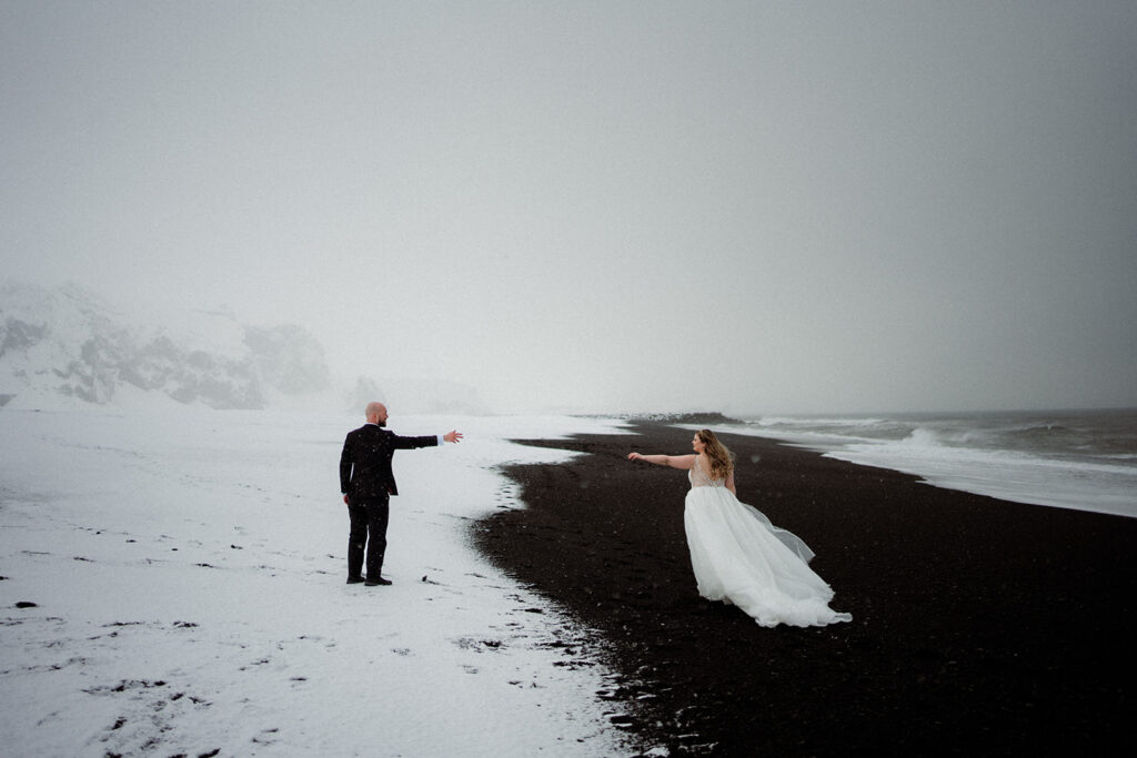 a couple who eloped in Iceland in the black sand beach say their vows in an intimate ceremony in winter
