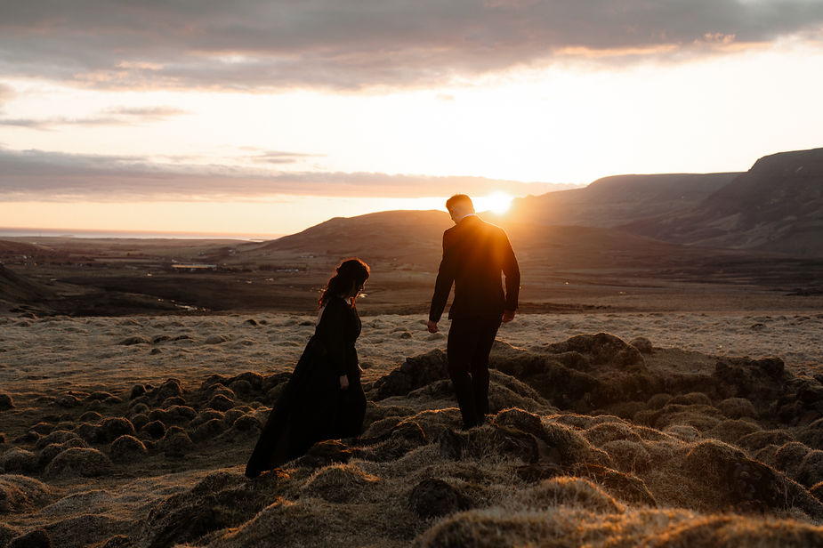 A couple stands on a hill during Sunset Elopement with Iceland Wedding Photographer, Lia Photo Stories.