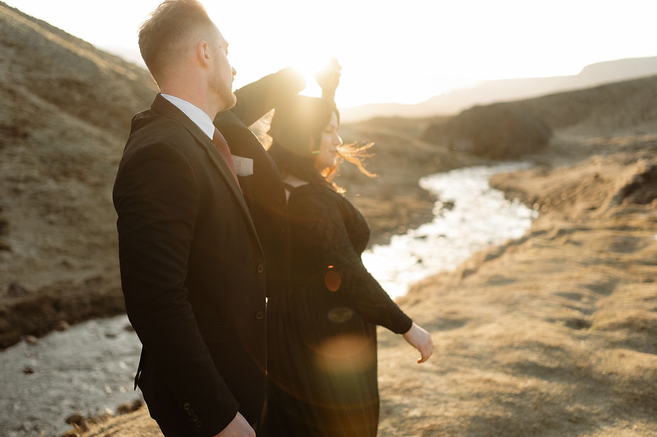 Husband twirls his wife with Helgufoss Valley in the background during Intimate Elopement with Iceland Wedding Photographer, Lia Photo Stories.