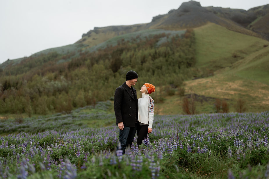 Couples photo in a field of flowers during family photos by iceland wedding photographer.