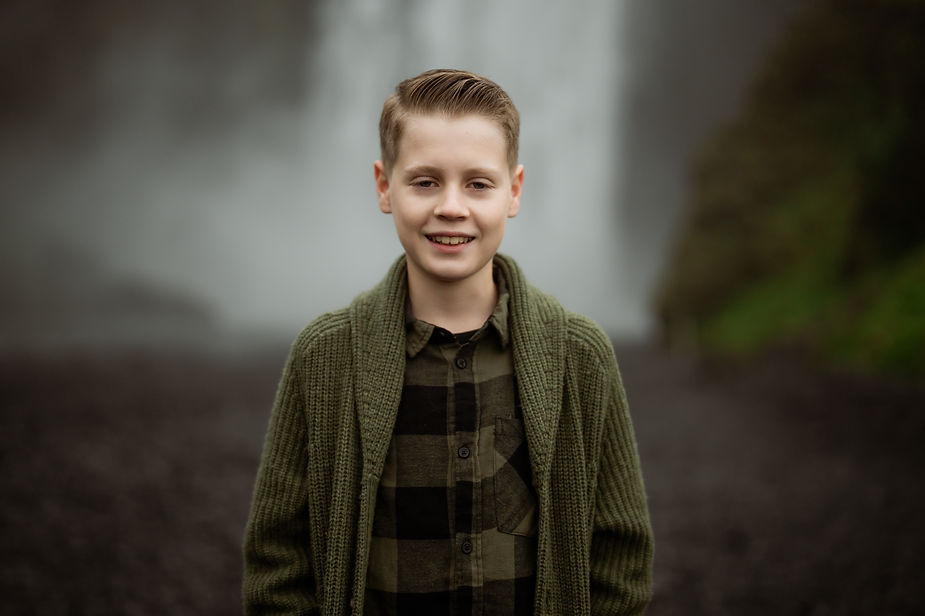 Boy in front of waterfall during Iceland Family Photo Session.
