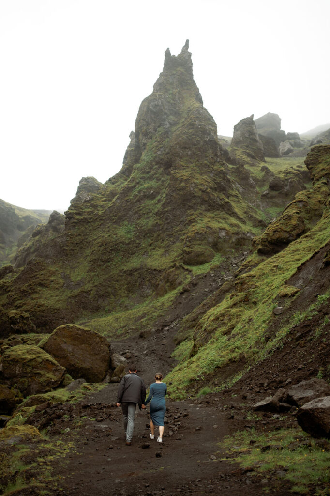 engaged couple walks on trail in iceland during engagement photo shoot with elopement photographer.