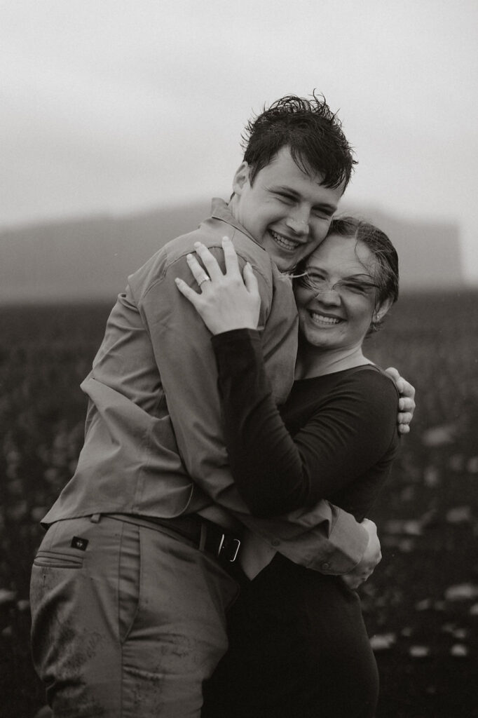 engaged couple smiles and hugs during surprise iceland proposal pictures.