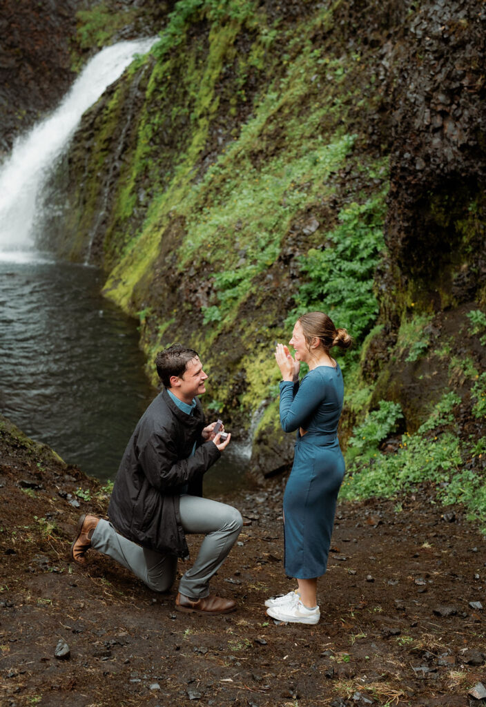 man is kneeled on one knee and proposes to woman during iceland proposal pictures.