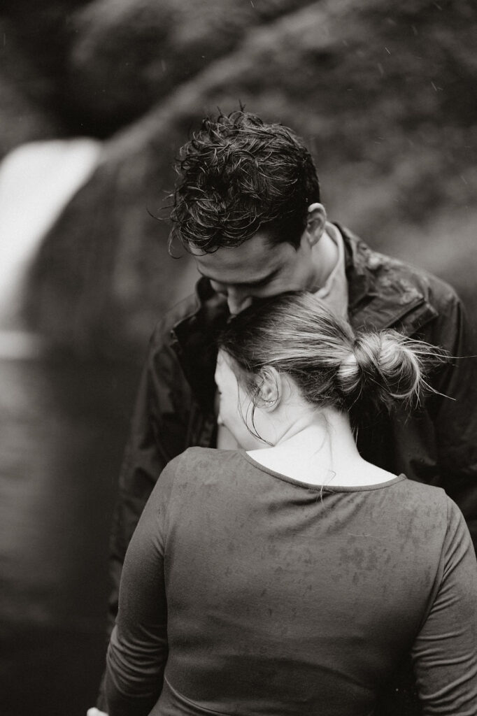 man kisses womans head during iceland engagement pictures with elopement photographer.