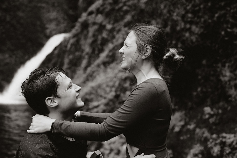 man and woman smile with pure joy during adventure proposal in iceland.