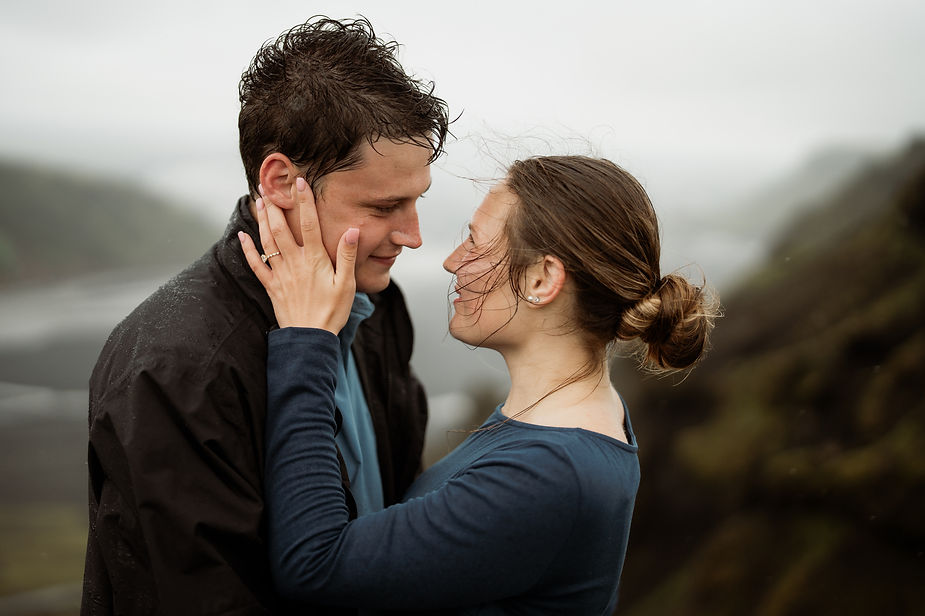 woman holds man face in her hands during iceland engagement photo shoot with elopement photographer.