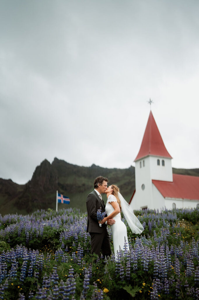 bride and groom kiss in front of church during iceland elopement.