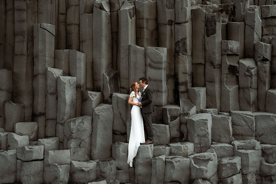 newlywed couple poses on rocks for iceland elopement photographer.