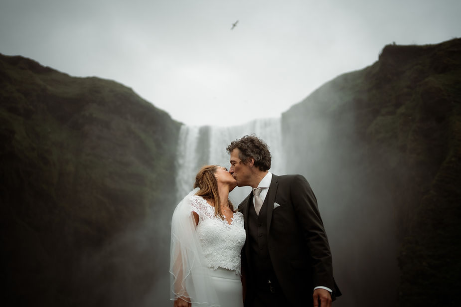 newlywed couple kisses during iceland wedding portraits.