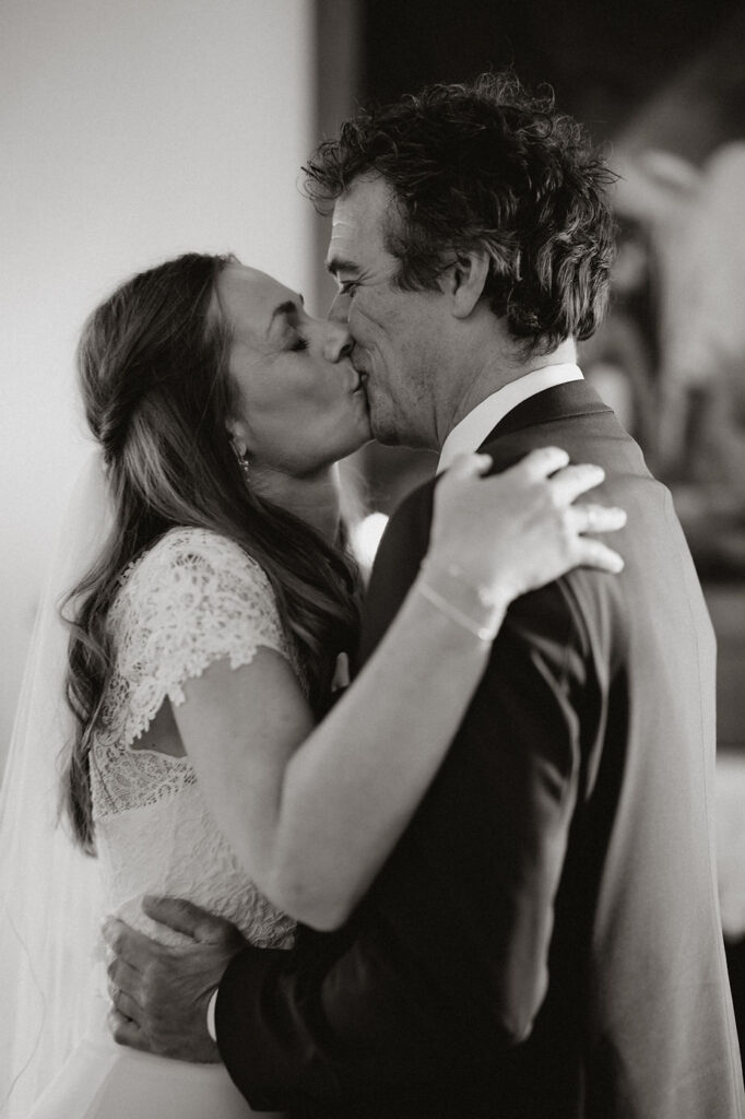 bride and groom kiss during iceland church wedding ceremony.