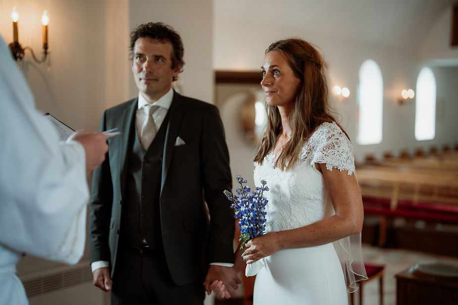 iceland wedding photographer snaps a shot of bride and groom during iceland church elopement.