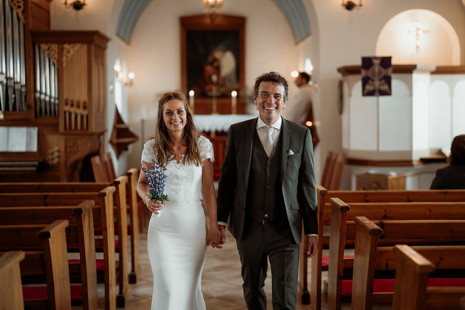bride and groom walk down aisle during iceland wedding ceremony.