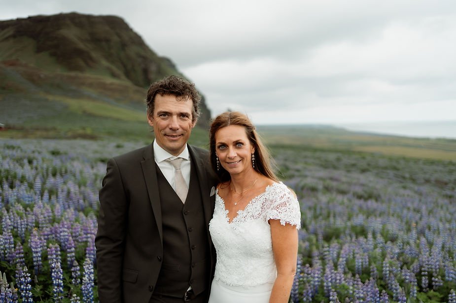 bride and groom pose for wedding portraits by iceland elopement photographer.