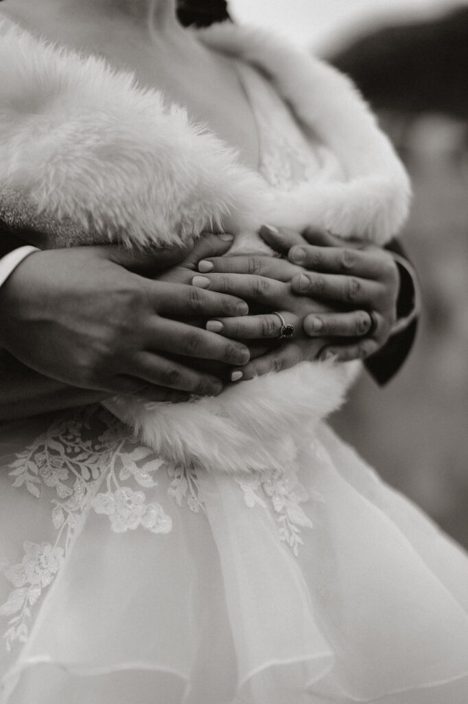 black and white close up image of bride and grooms hands and wedding rings during iceland wedding photos.