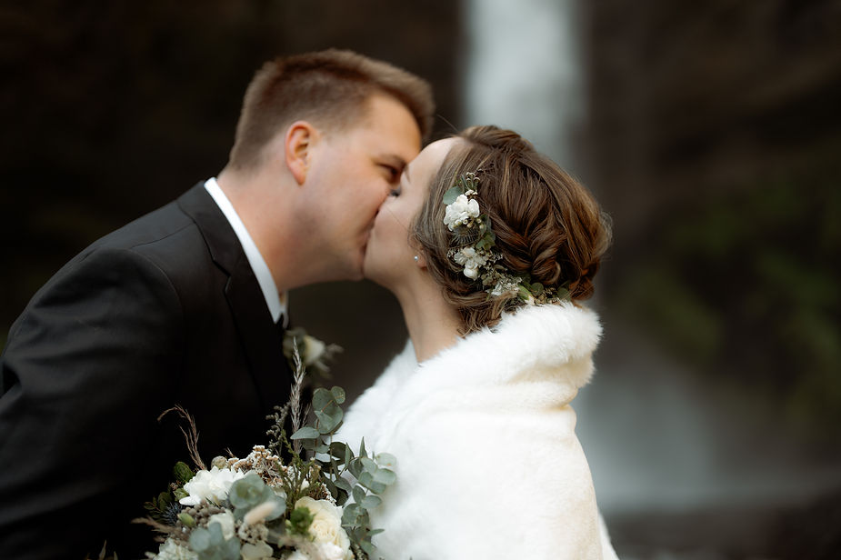 bride and groom kiss during iceland elopement.