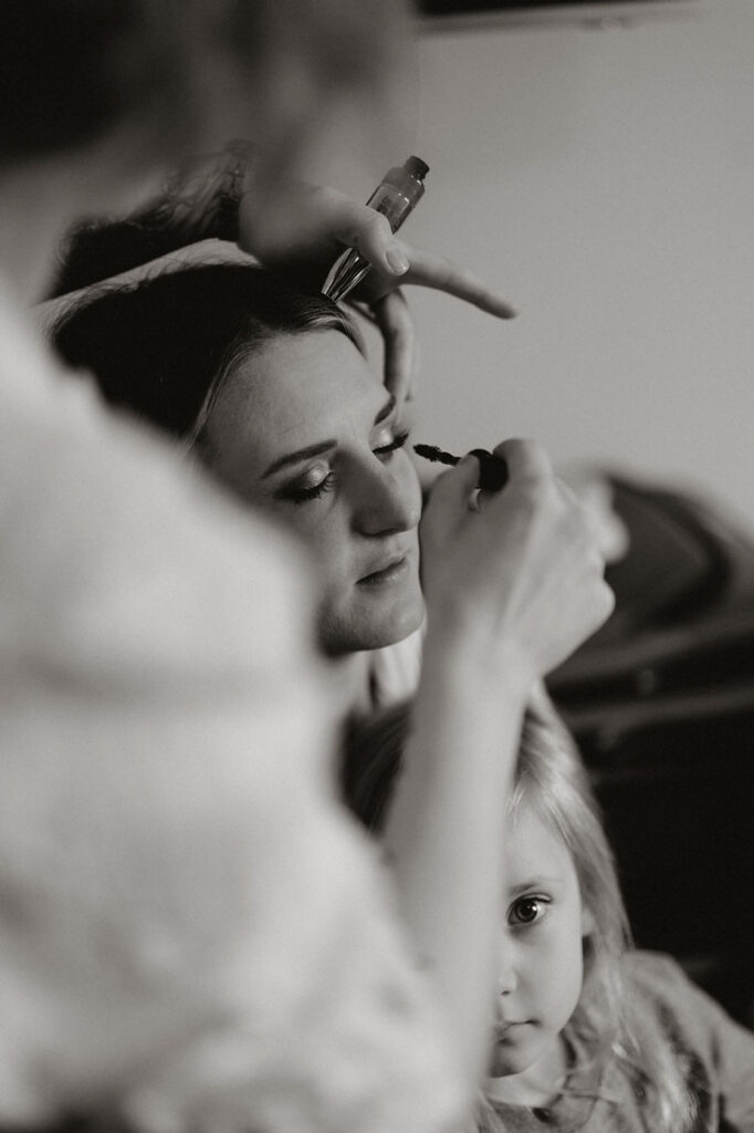 black and white photo of bride getting ready for her iceland wedding ceremony.