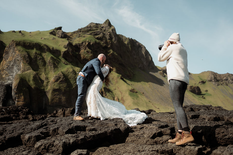 iceland elopement photographer takes a photo of bride and groom on westman island.