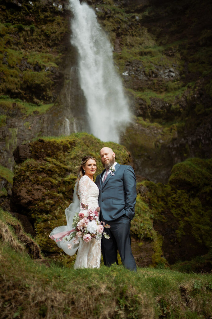 bride stands behind groom for first look during iceland adventure elopement photos.