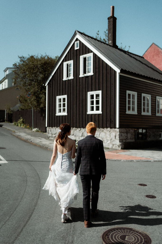 lgbtqi+ couple walks around downtown reykjavik during their destination wedding in iceland.