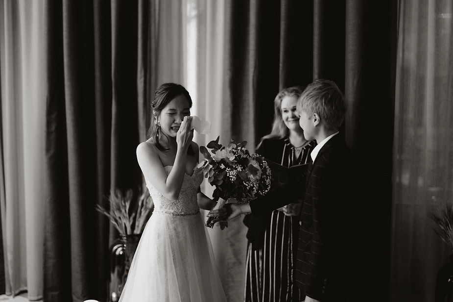 bride wipes tear from her eye during their intimate wedding in iceland.
