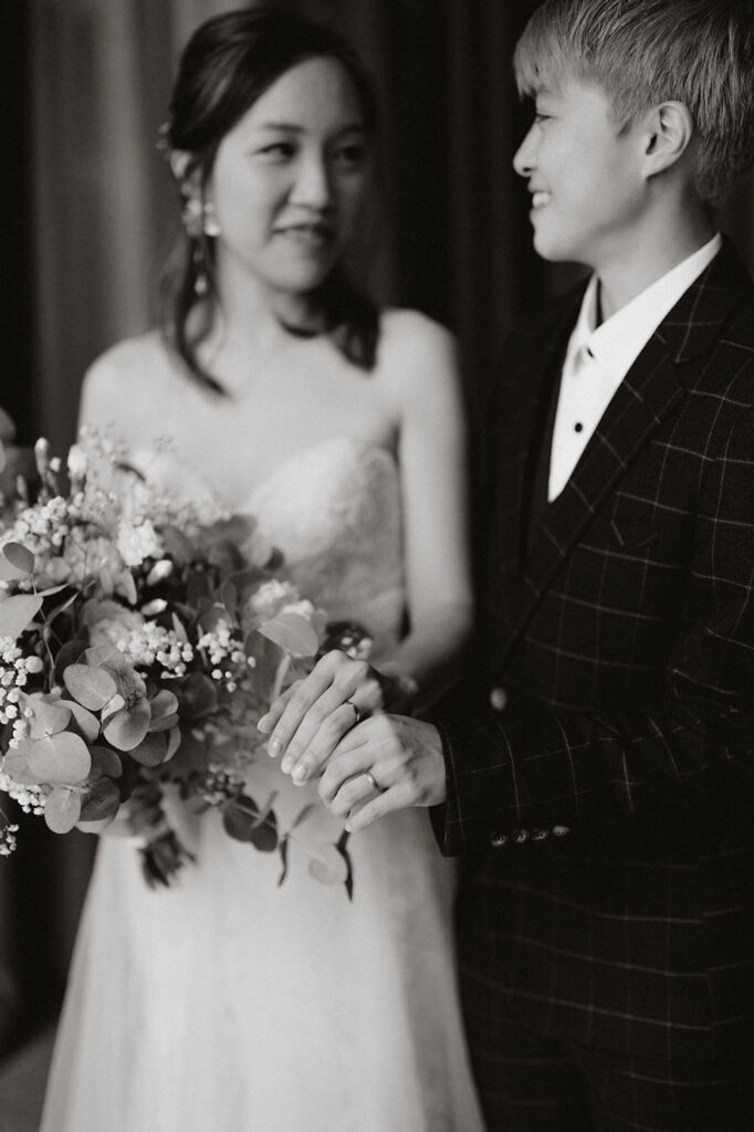 lgbtqi+ couple look at each other during their destination wedding in iceland.