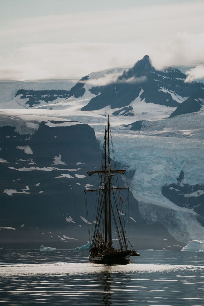 destination wedding photographer takes a photo of a sailboat in Greenland.