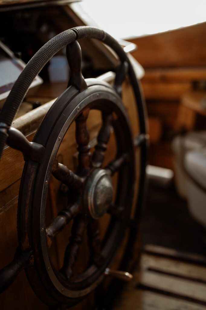 close up image of sailboat steering wheel during greenland adventure.