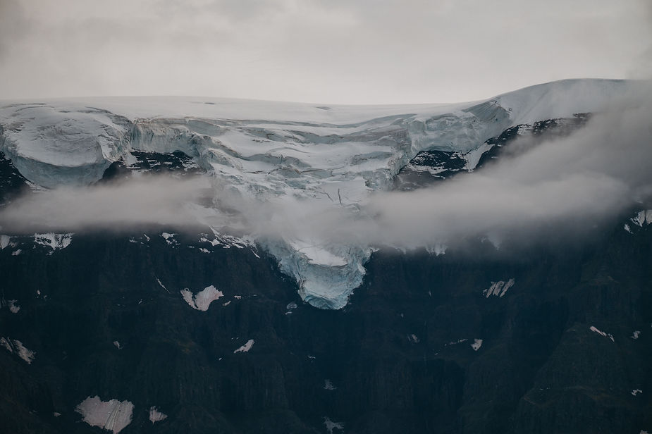 giant rock face with glacier on top during greenland adventure wedding.
