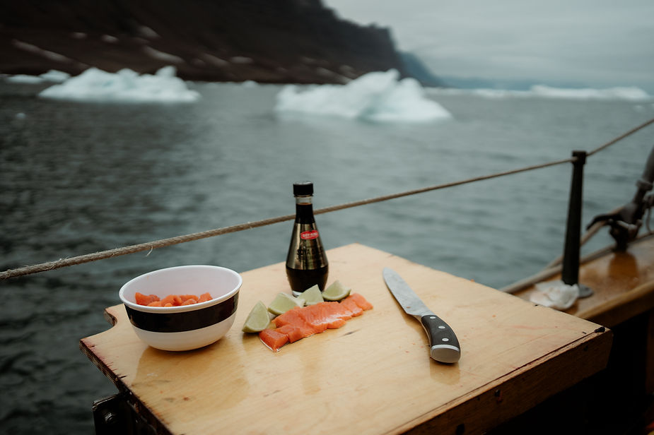 fresh fish meal on sailboat during greenland elopement wedding.
