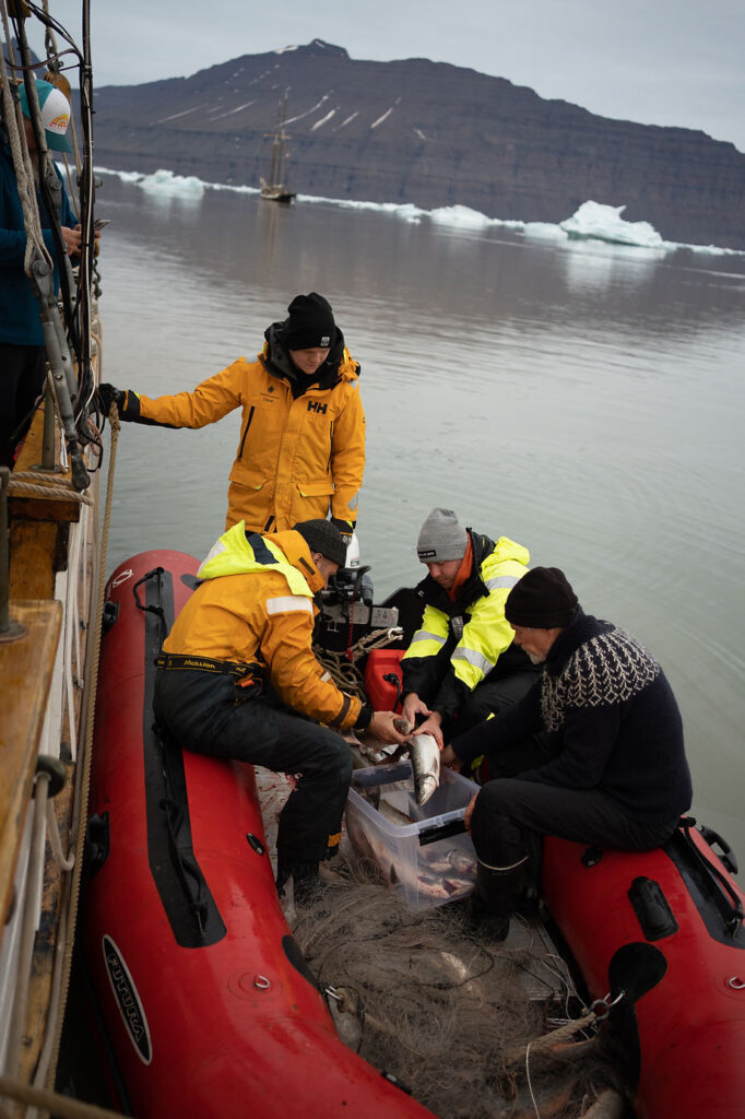 fishermen in a small boat during greenland adventure wedding.