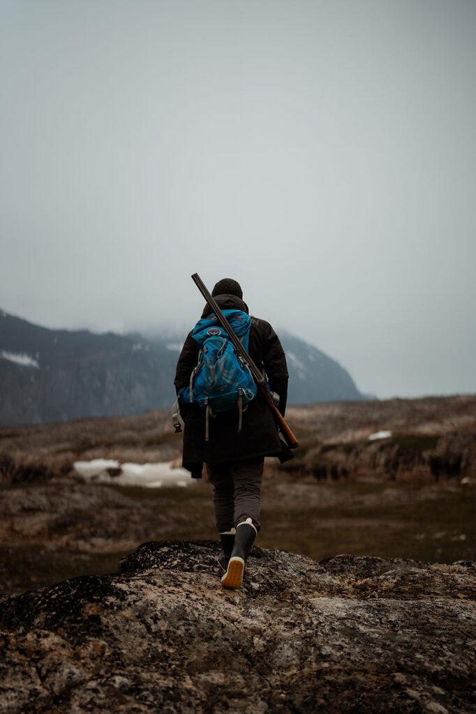 persona walks through greenland during adventure wedding.