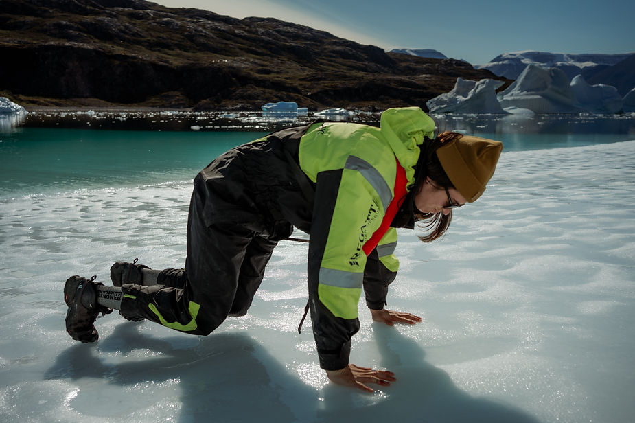 iceland elopement photographer gets down on ice during destination elopement in greenland.