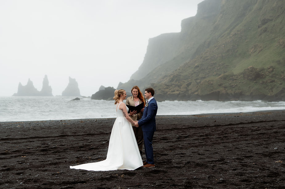 bride and groom get married on black sand beach in iceland.