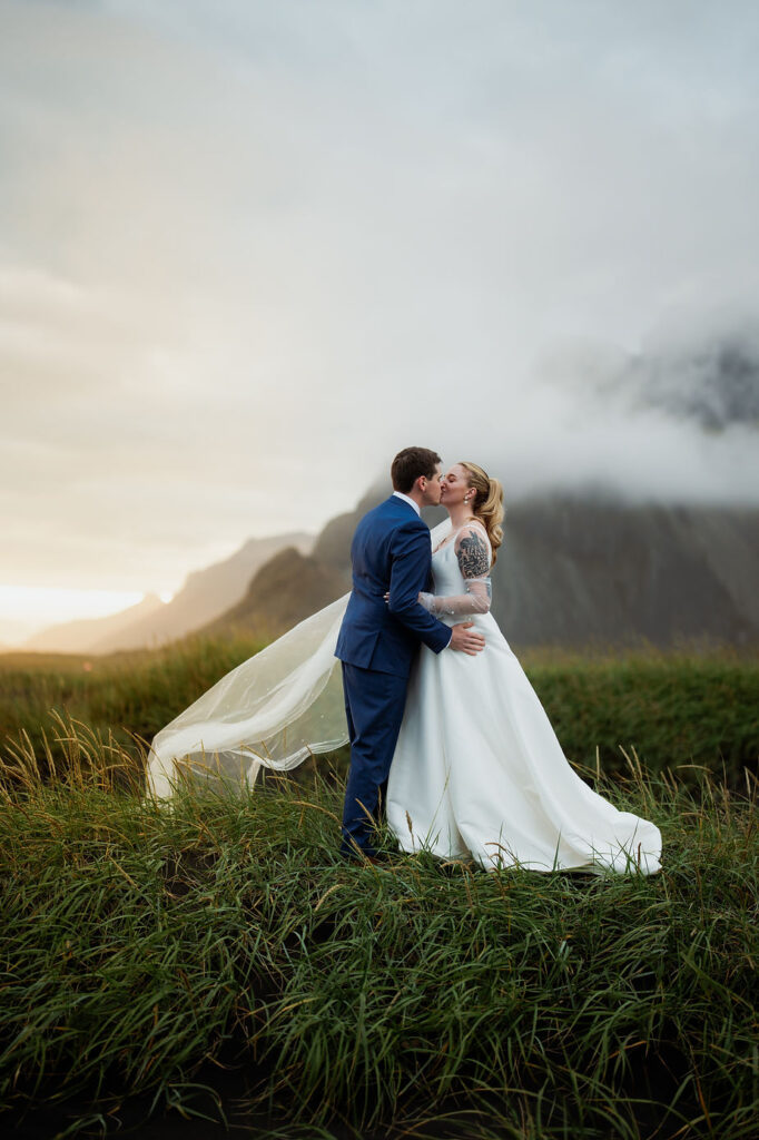 bride and groom kiss during sunset photos with iceland wedding photographer.