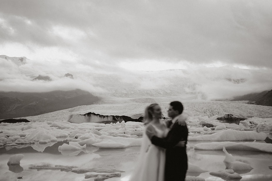 bride and groom embrace during adventure elopement with iceland wedding photographer.