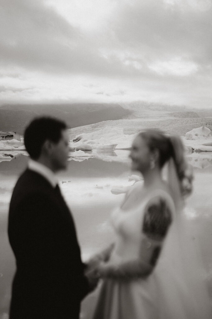 bride and groom, with glacier in the back, during iceland wedding adventure.
