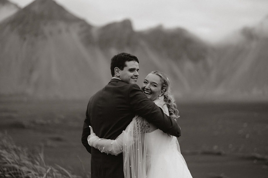 bride and groom look at iceland wedding photographer and smile during adventure elopement.